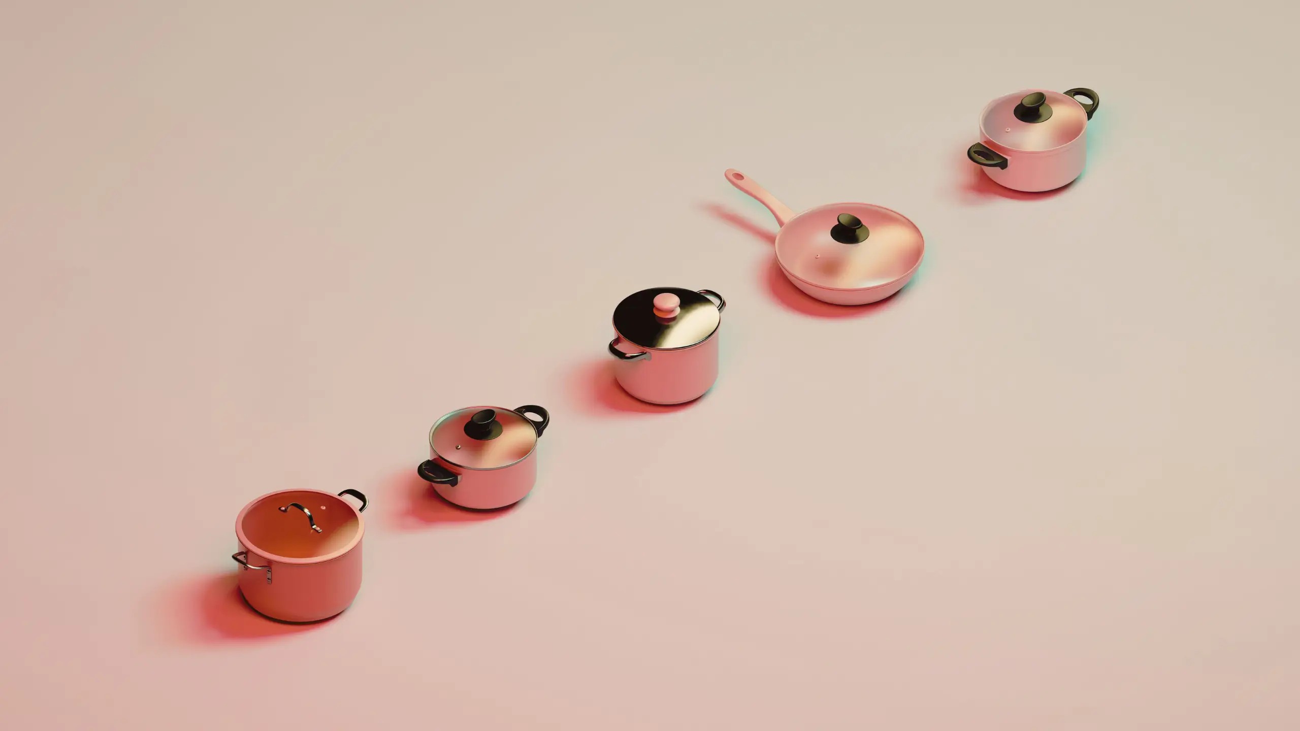 A line of cooking pots and pans in differing shades of peach.