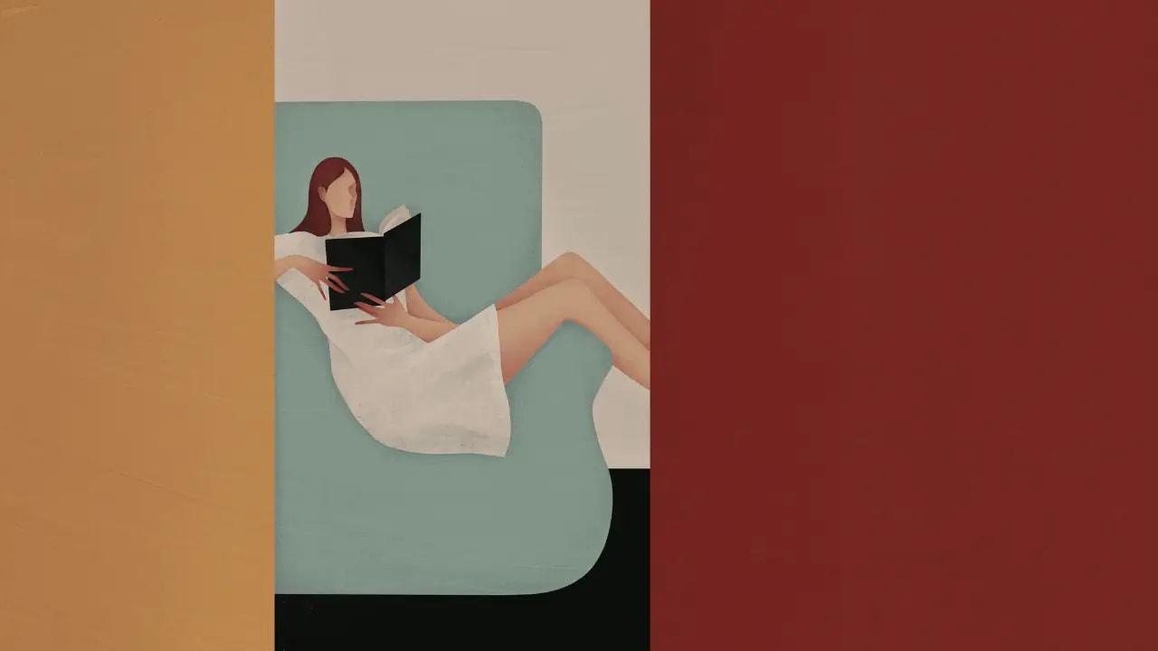 Looking through a doorway at a woman in a white dress sitting comfortably across an armchair, reading a book.