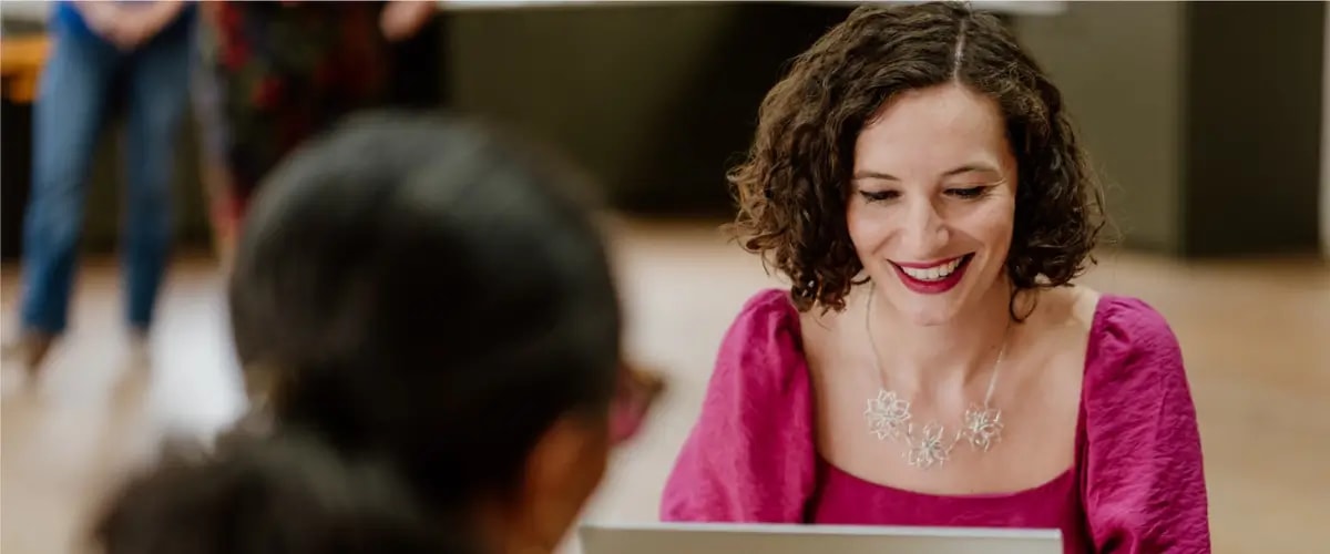 Author and writing coach Bea Fitzgerald works on a laptop.